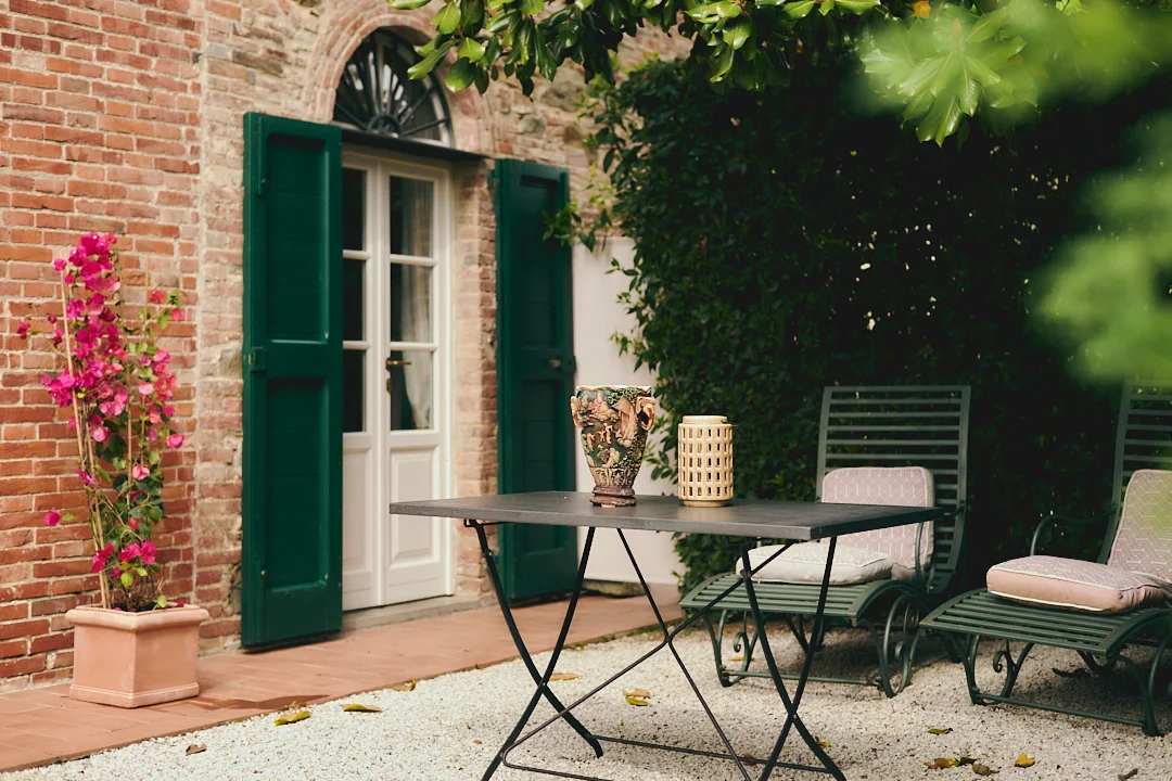Brick terrace and green shutters at Villa Niccolai film location